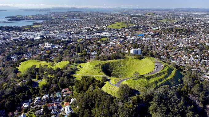 Vulkanismus unter Großstädten Luftbild Vulkankegel vor Siedlung